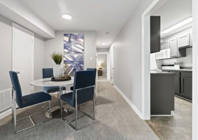 A modern kitchen and dining area within a condo, highlighting elegant decor and efficient use of space for dining and cooking